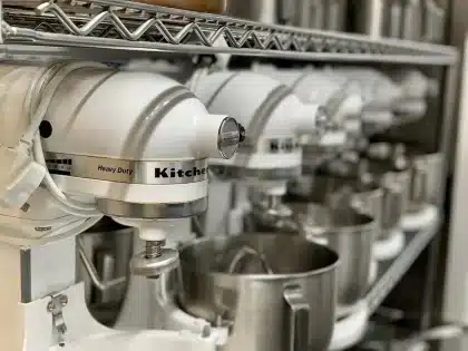 Mani anonime impiattano piccoli insetti commestibili in cucina professionale